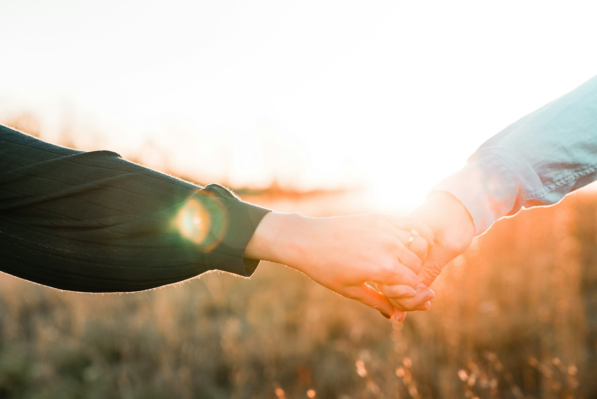 Two hands held together at sunset