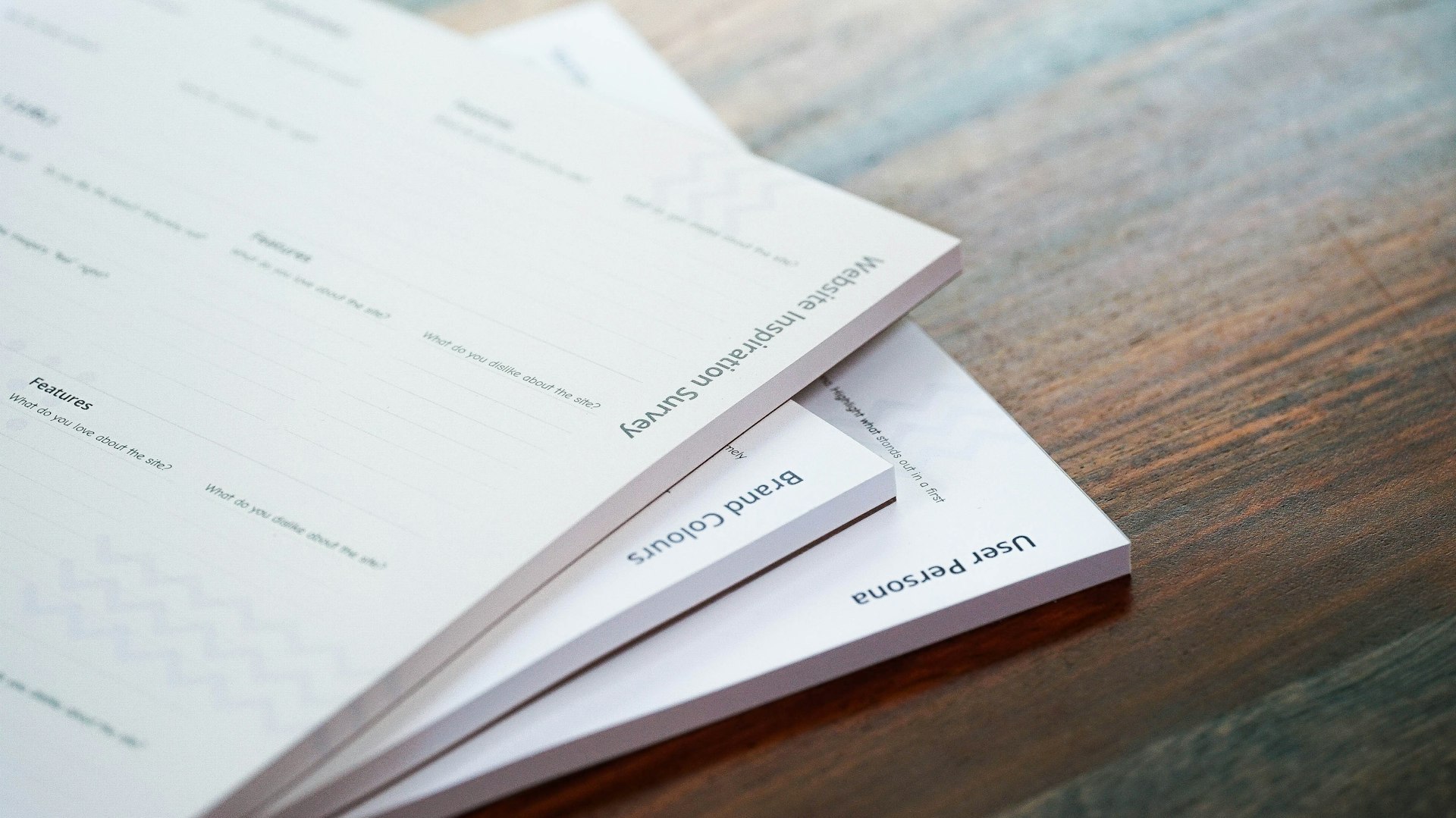 Stack of papers on a warm wooden table